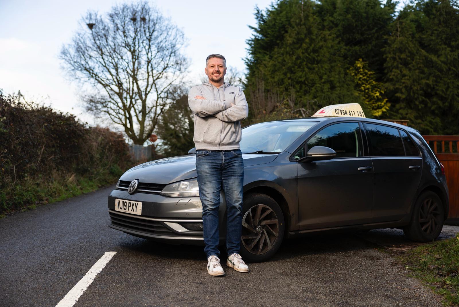 Josh beside his teaching car